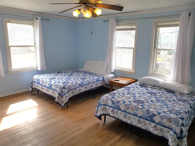 a bedroom with two beds and a chandelier