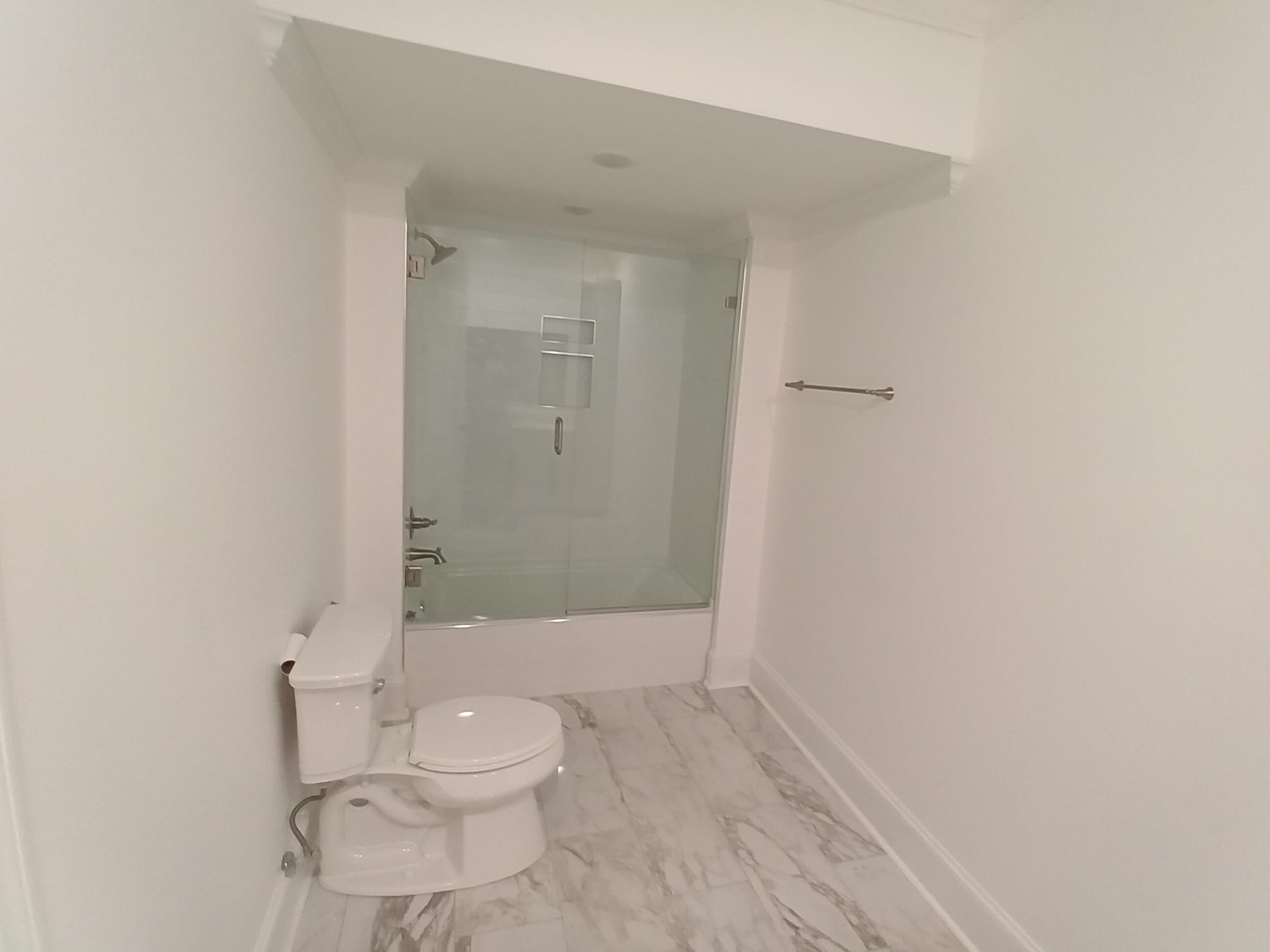 5690 Walnut Grove Road Memphis, TN 38120 - Photo 22 of 40 a bathroom with a granite countertop toilet and a shower