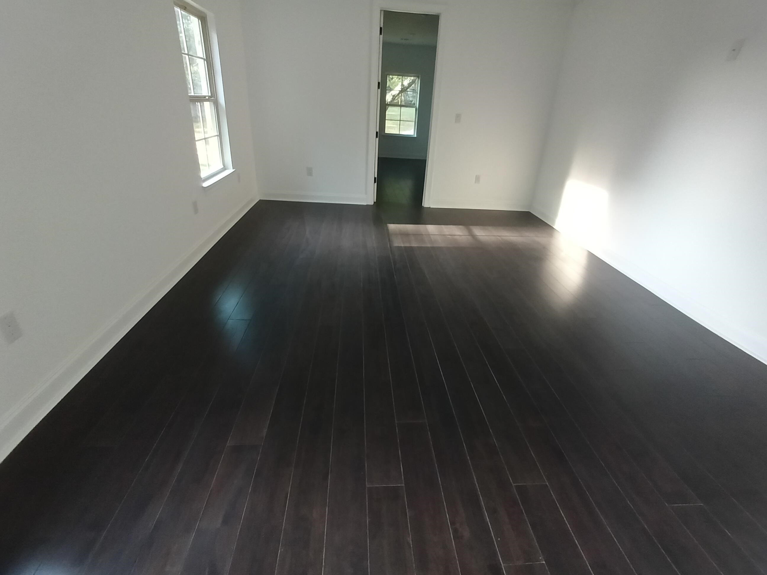 5690 Walnut Grove Road Memphis, TN 38120 - Photo 27 of 40 an empty room with wooden floor and windows