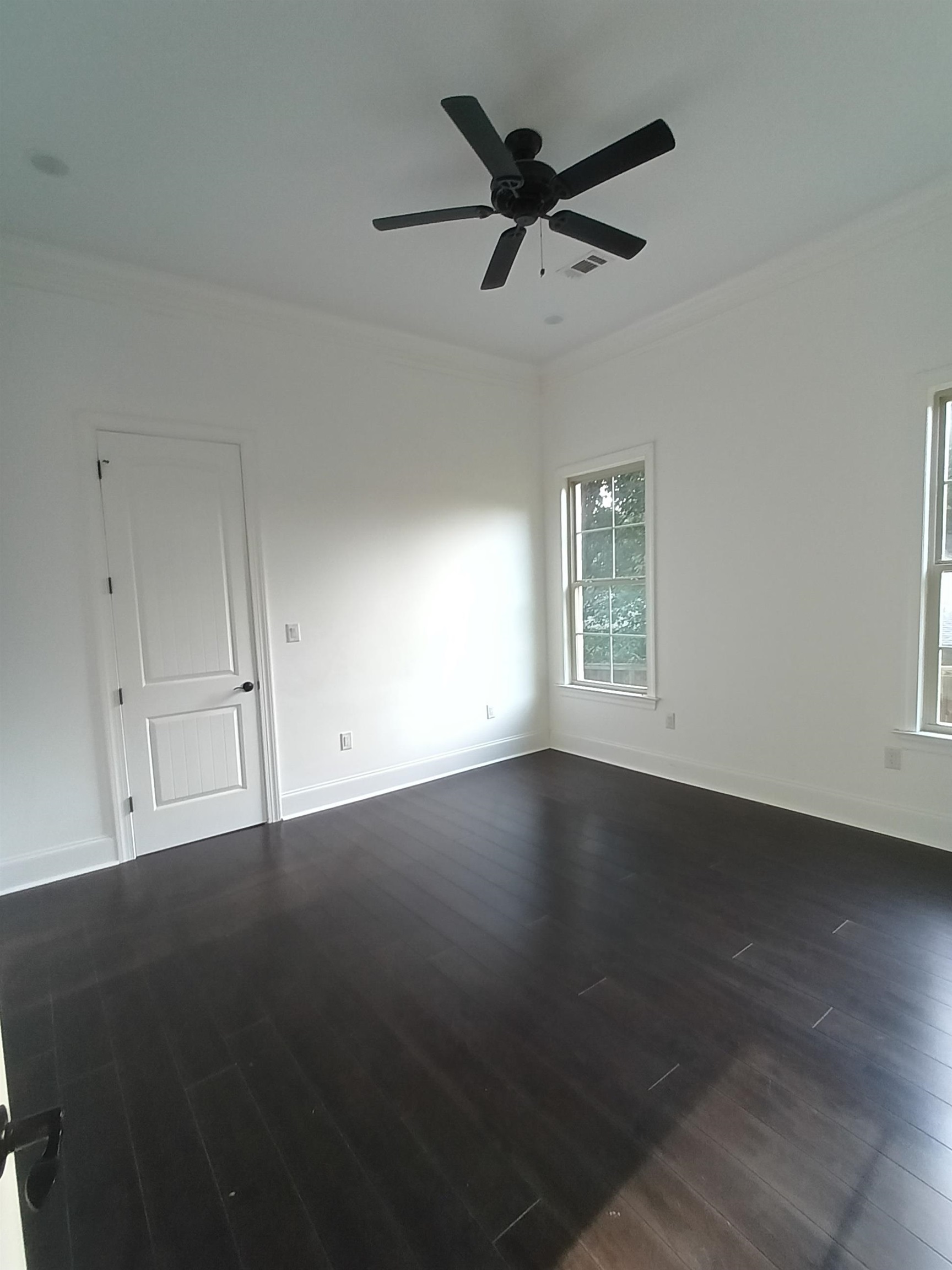 5690 Walnut Grove Road Memphis, TN 38120 - Photo 28 of 40 an empty room with wooden floor fan and windows