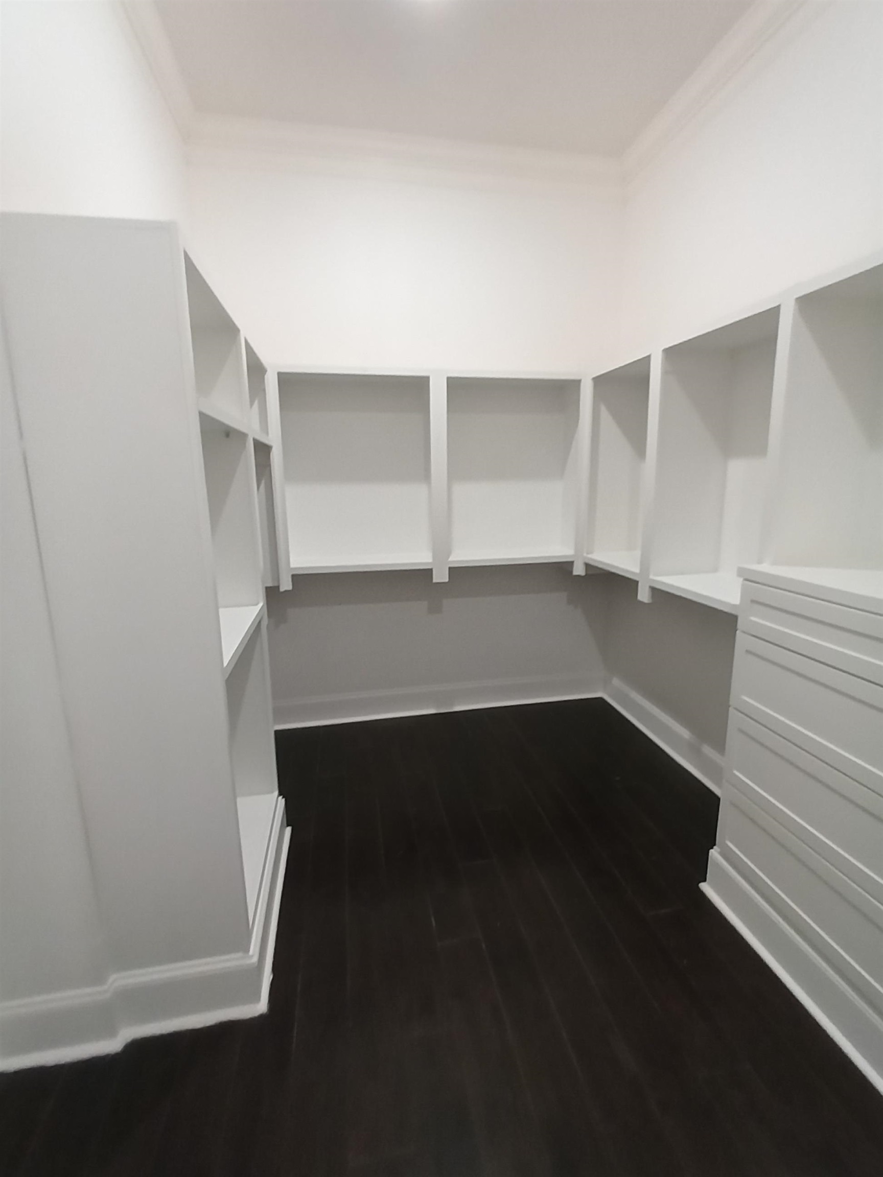 5690 Walnut Grove Road Memphis, TN 38120 - Photo 32 of 40 an empty room with wooden floor and cabinet