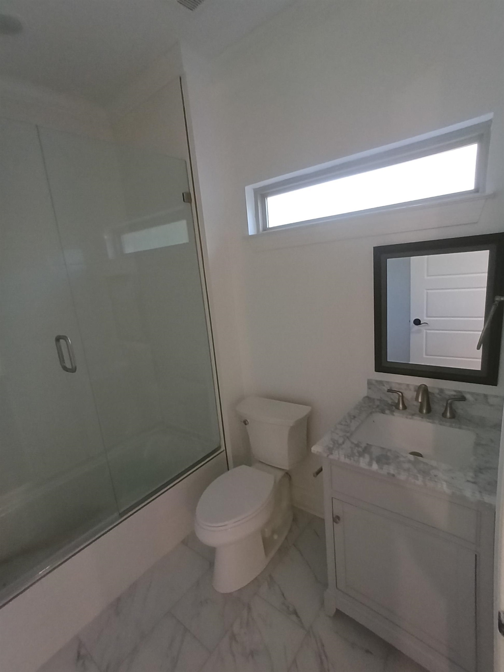 5690 Walnut Grove Road Memphis, TN 38120 - Photo 34 of 40 a white toilet sitting next to a bathroom sink