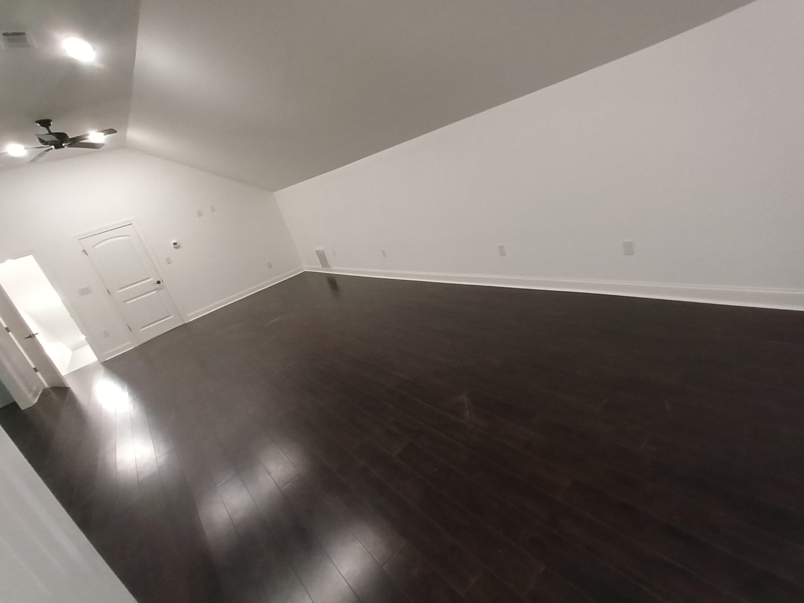 5690 Walnut Grove Road Memphis, TN 38120 - Photo 36 of 40 an empty room with wooden floor and windows