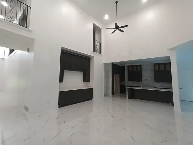 a view of an empty room with closet and cabinet