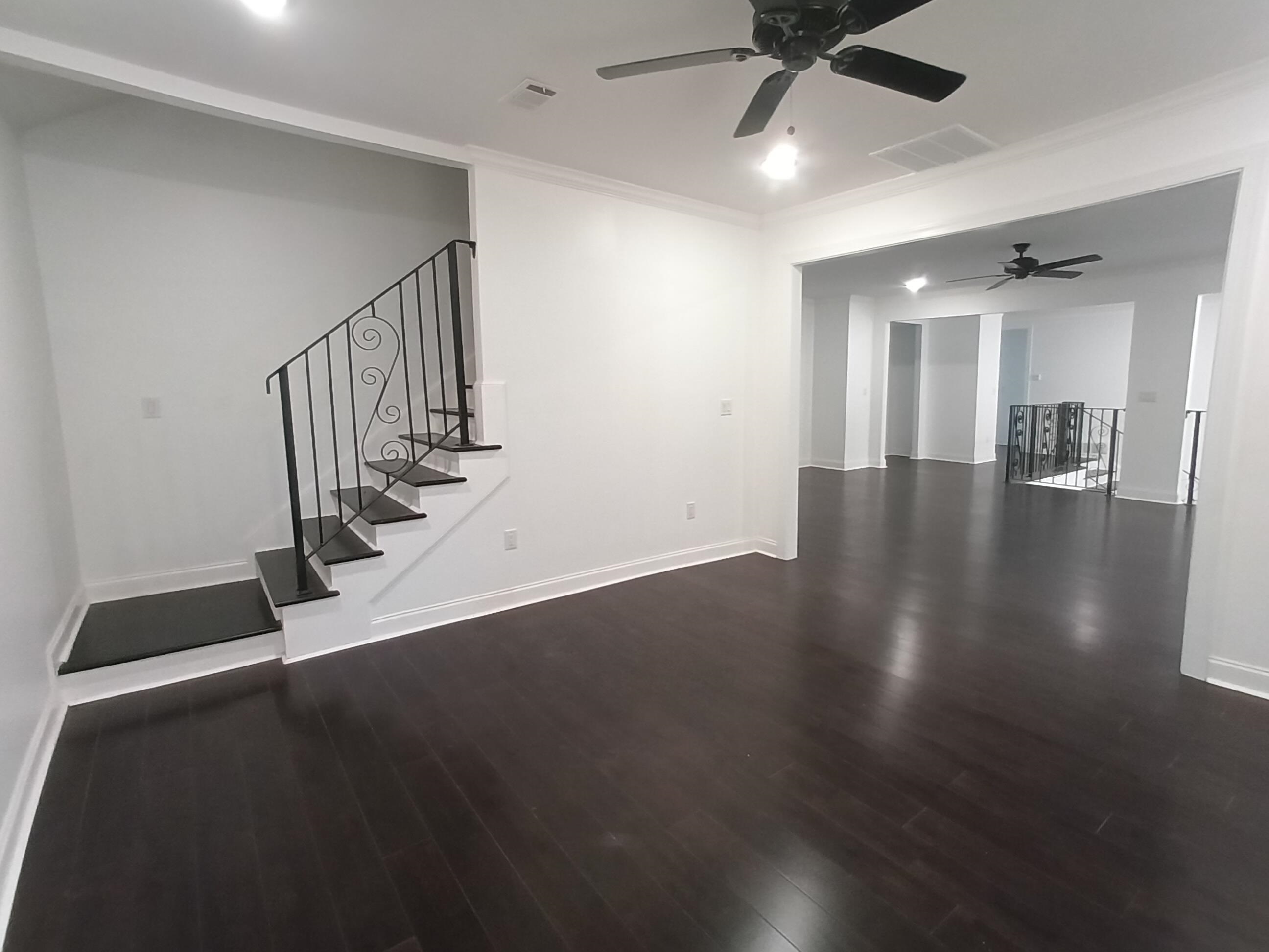 5690 Walnut Grove Road Memphis, TN 38120 - Photo 8 of 40 an empty room with wooden floor and windows