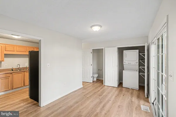 an empty room with closet and wooden floor
