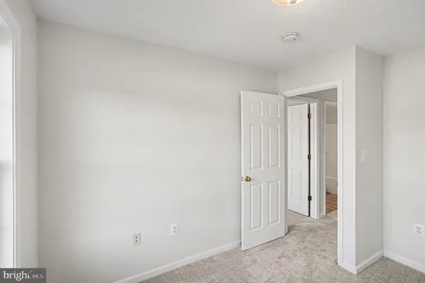 a view of an empty room with wooden walls
