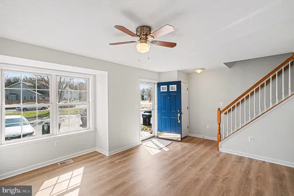 a view of an entryway with wooden floor