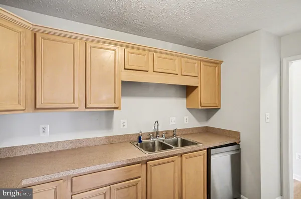 a kitchen with a sink cabinets and window