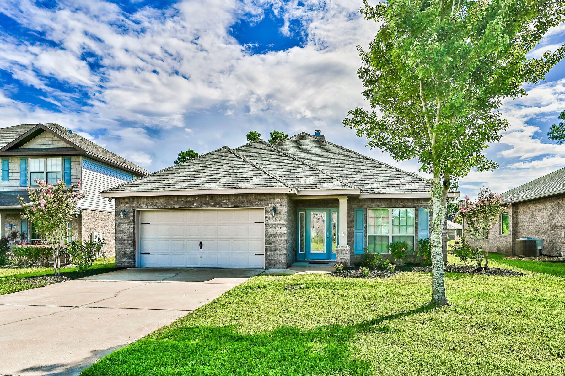 96 Pin Oak Loop Santa Rosa Beach, FL 32459 - Photo 1 of 47 a view of a white house with a big yard and large tree