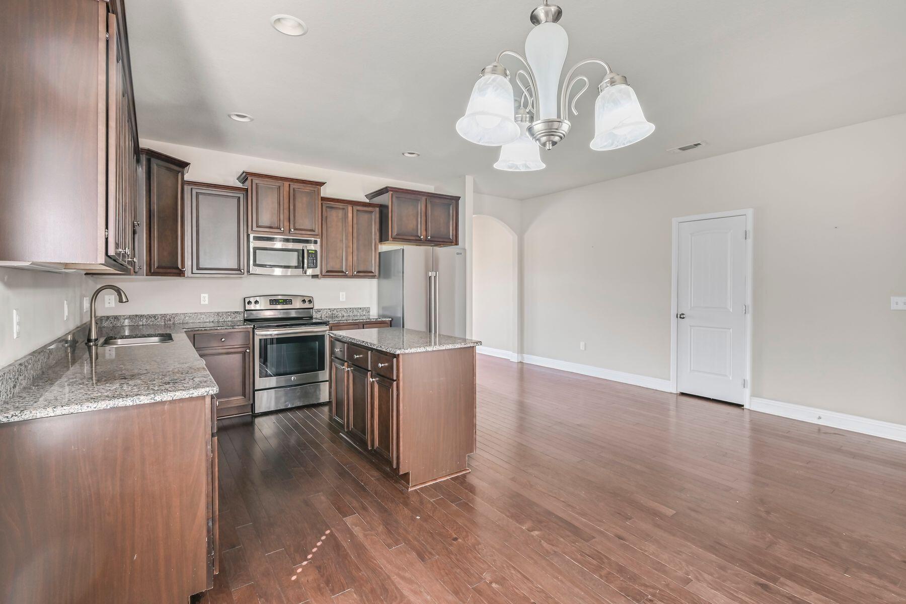 96 Pin Oak Loop Santa Rosa Beach, FL 32459 - Photo 14 of 47 a kitchen with kitchen island granite countertop stainless steel appliances a stove sink and refrigerator