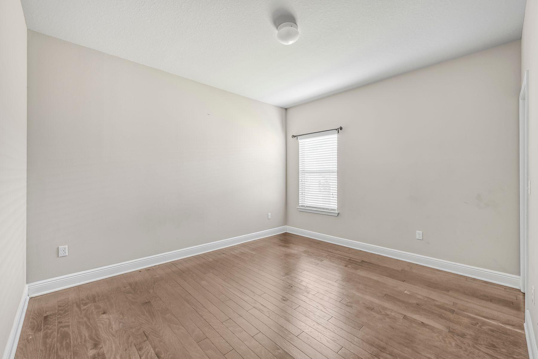 96 Pin Oak Loop Santa Rosa Beach, FL 32459 - Photo 27 of 47 an empty room with wooden floor and windows