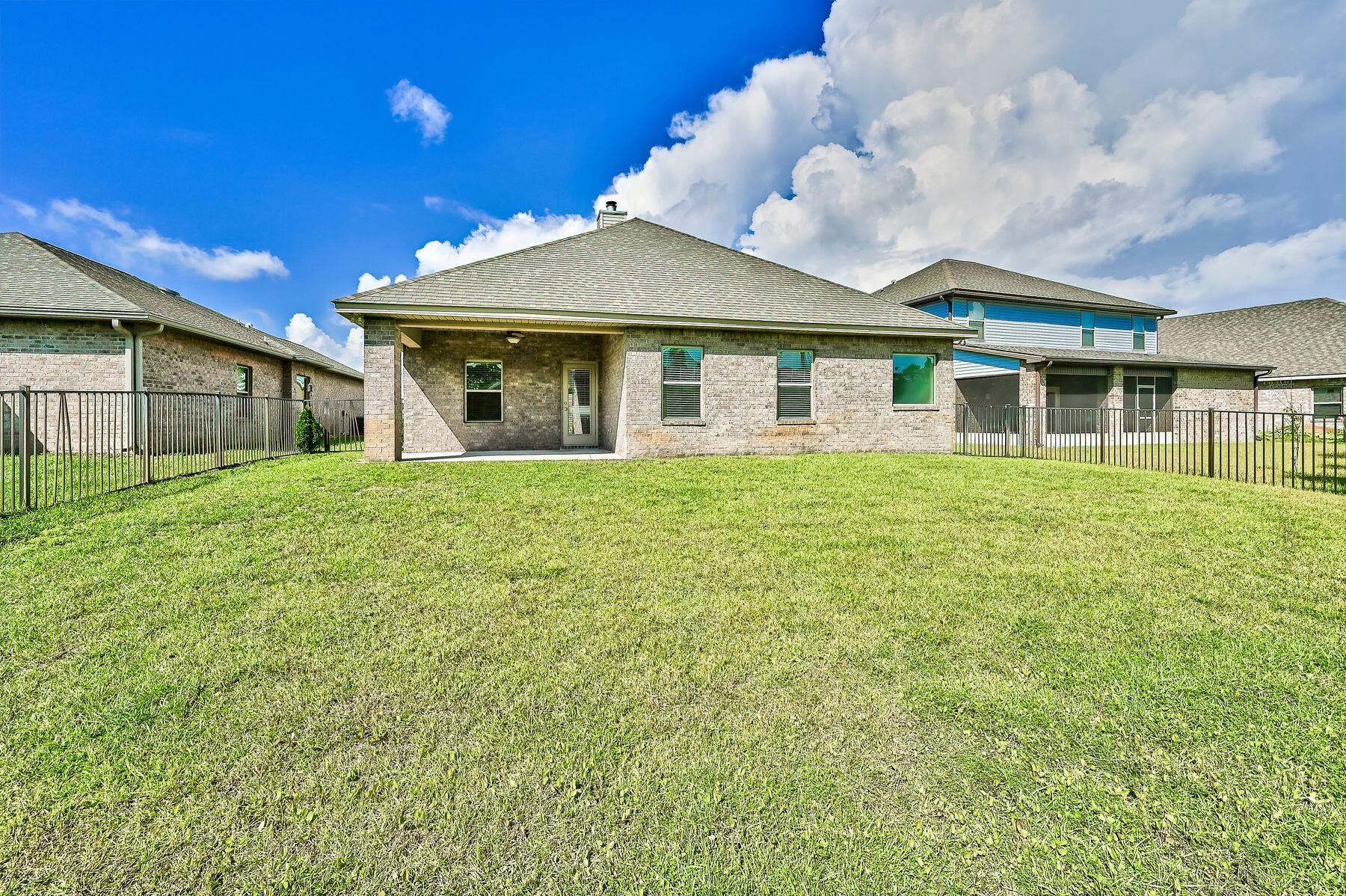 96 Pin Oak Loop Santa Rosa Beach, FL 32459 - Photo 3 of 47 a front view of a house with a garden
