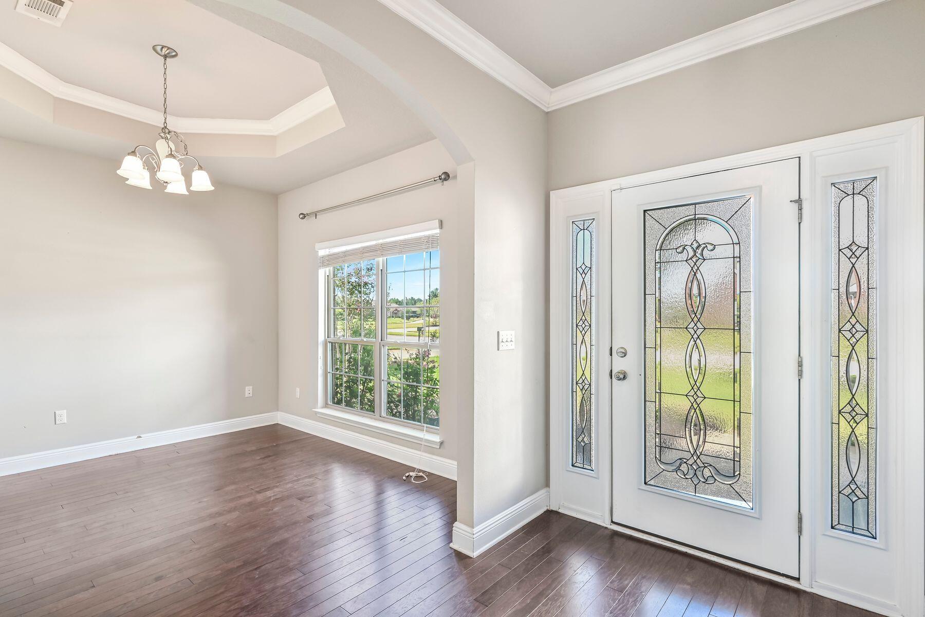 96 Pin Oak Loop Santa Rosa Beach, FL 32459 - Photo 8 of 47 a view of an empty room with wooden floor and a window