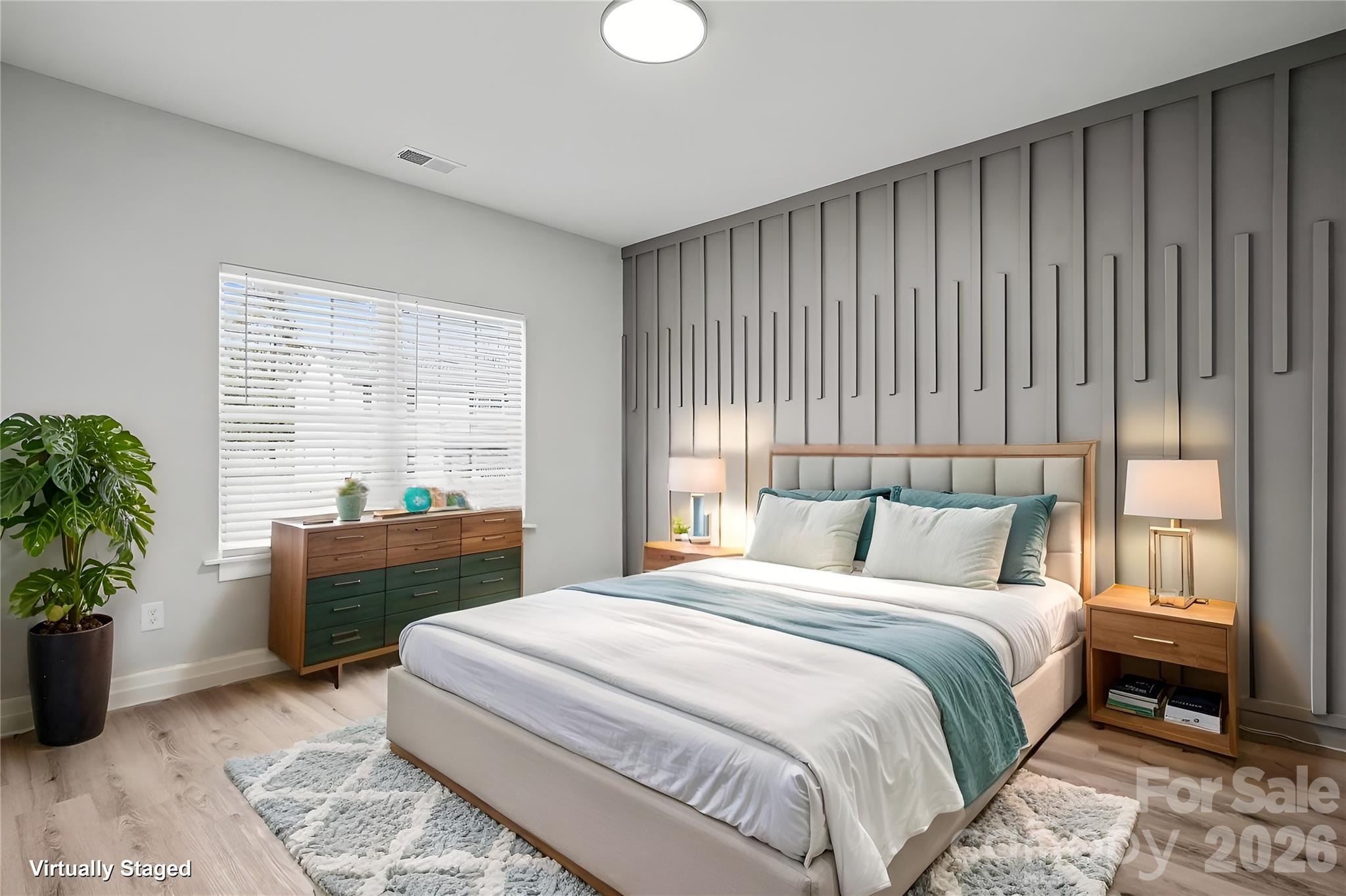 5626 Torrence Street Charlotte, NC 28269 - Photo 11 of 27 a bedroom with a large bed and a window
