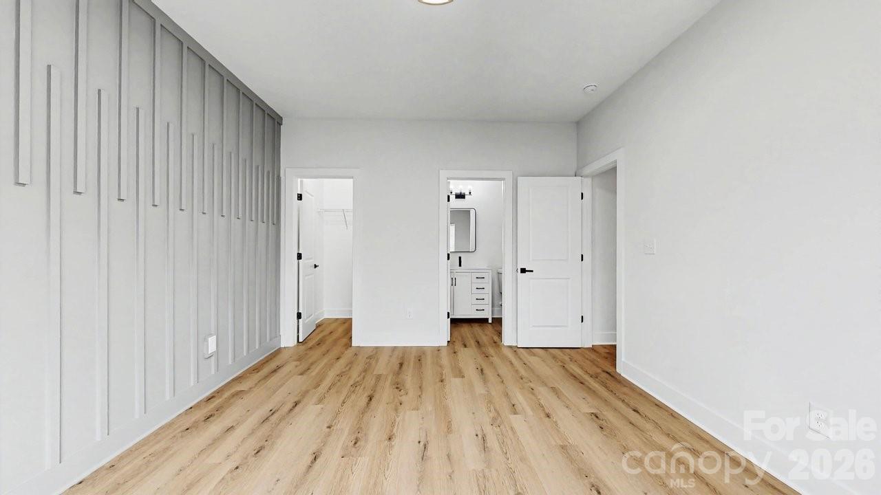 5626 Torrence Street Charlotte, NC 28269 - Photo 12 of 27 a view of empty room with wooden floor