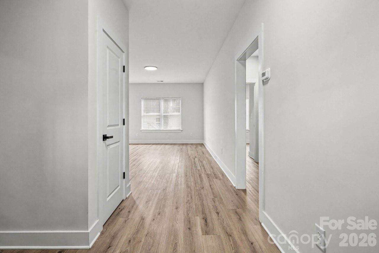 5626 Torrence Street Charlotte, NC 28269 - Photo 19 of 27 a view of a room with wooden floor and windows