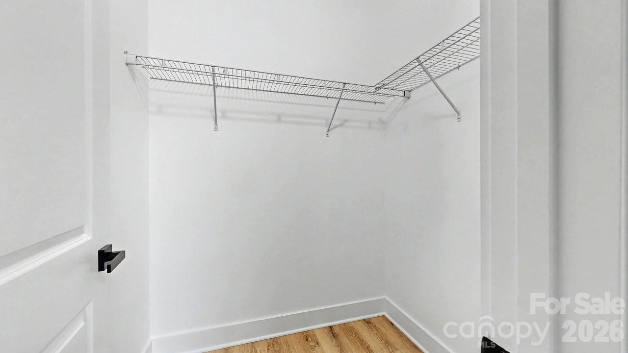 5626 Torrence Street Charlotte, NC 28269 - Photo 20 of 27 a view of a room with racks on the wall