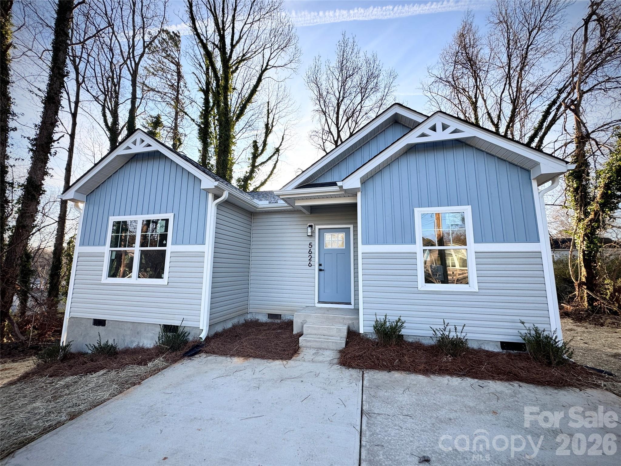 5626 Torrence Street Charlotte, NC 28269 - Photo 26 of 27 a front view of a house with a yard