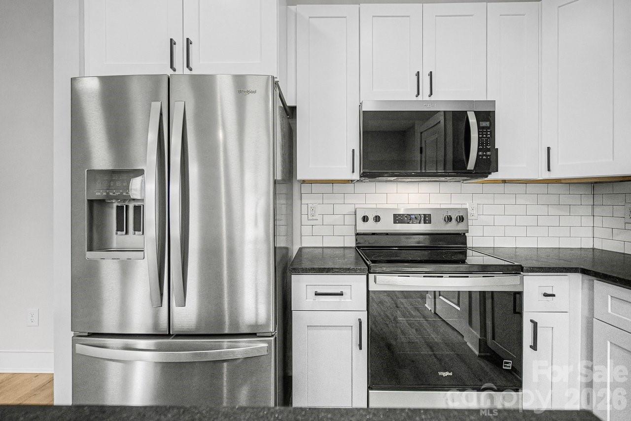 5626 Torrence Street Charlotte, NC 28269 - Photo 7 of 27 a kitchen with a stove and a refrigerator