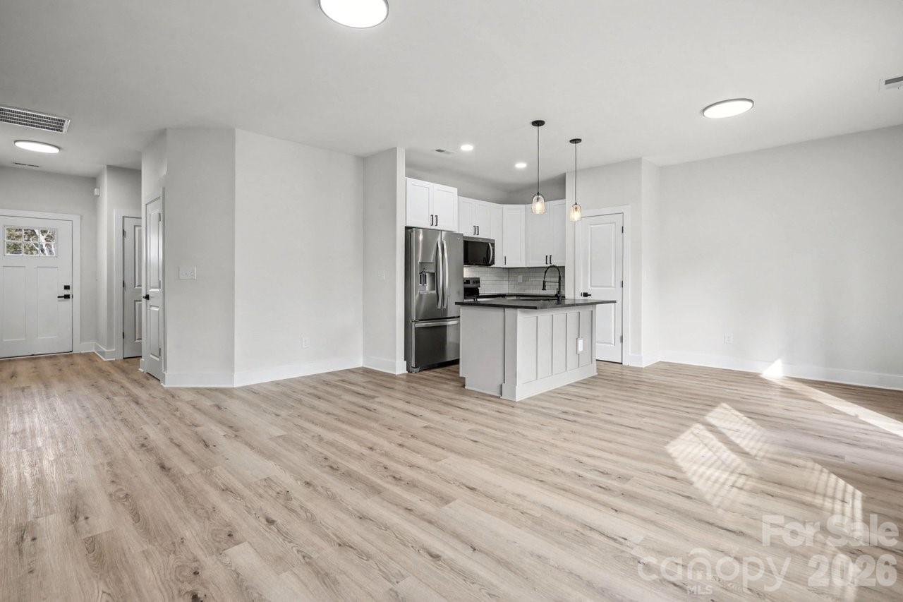 5626 Torrence Street Charlotte, NC 28269 - Photo 8 of 27 a view of kitchen with wooden floor