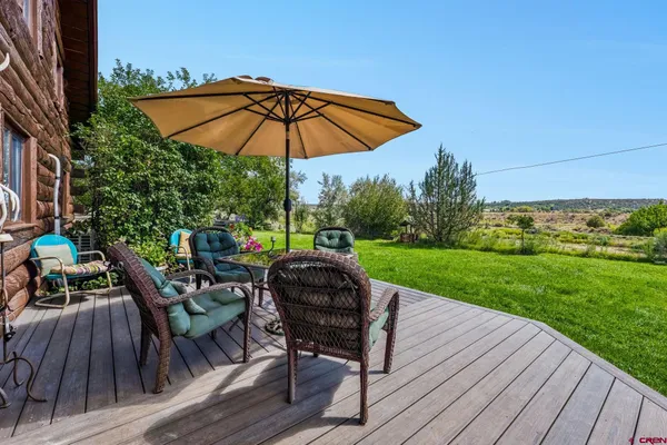 a view of a table and chairs under an umbrella