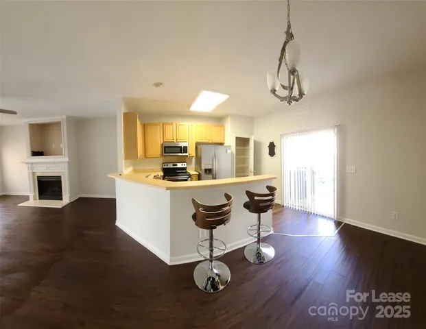 a living room with dining table and wooden floor