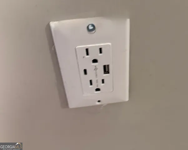 a bedroom with a bed mirror and window