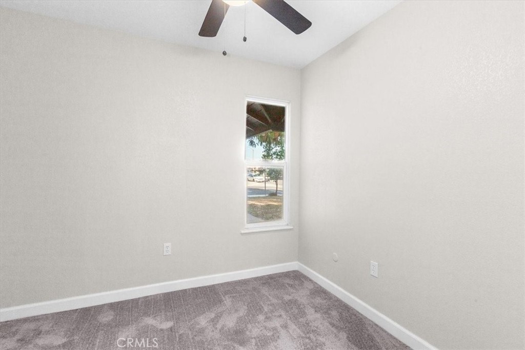 7900 Temecula Place Riverside, CA 92503 - Photo 11 of 22 an empty room with windows and fan