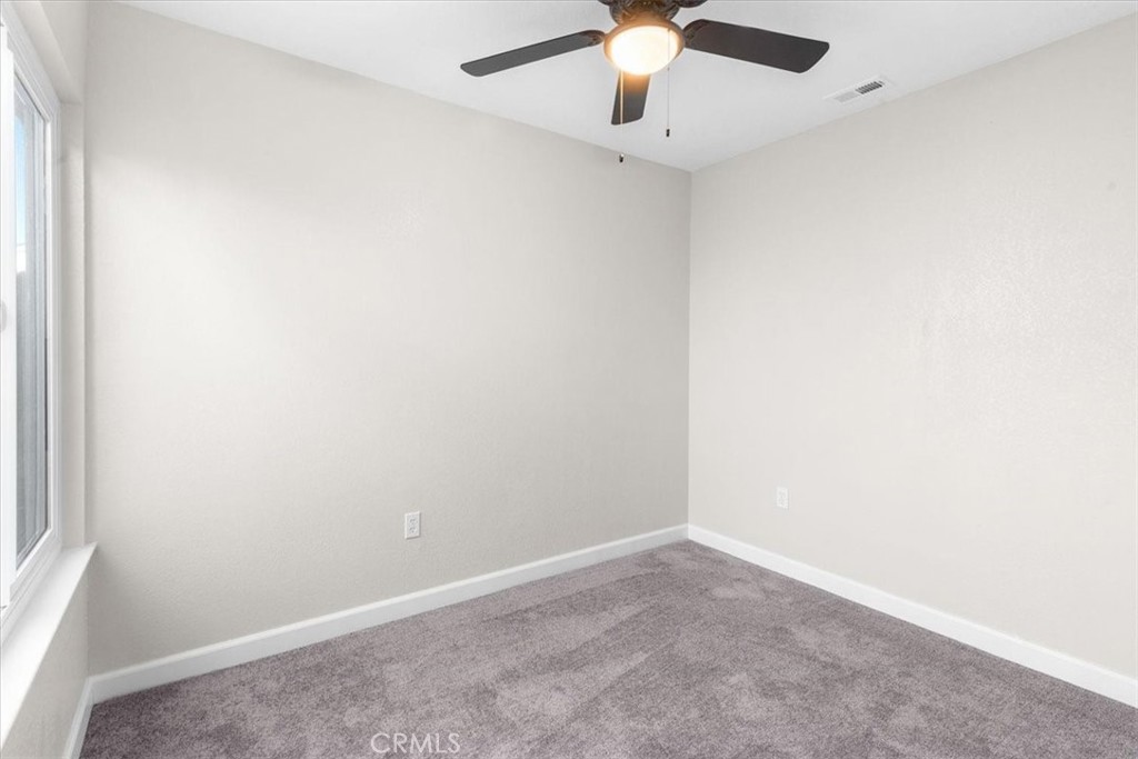 7900 Temecula Place Riverside, CA 92503 - Photo 14 of 22 an empty room with a chandelier fan