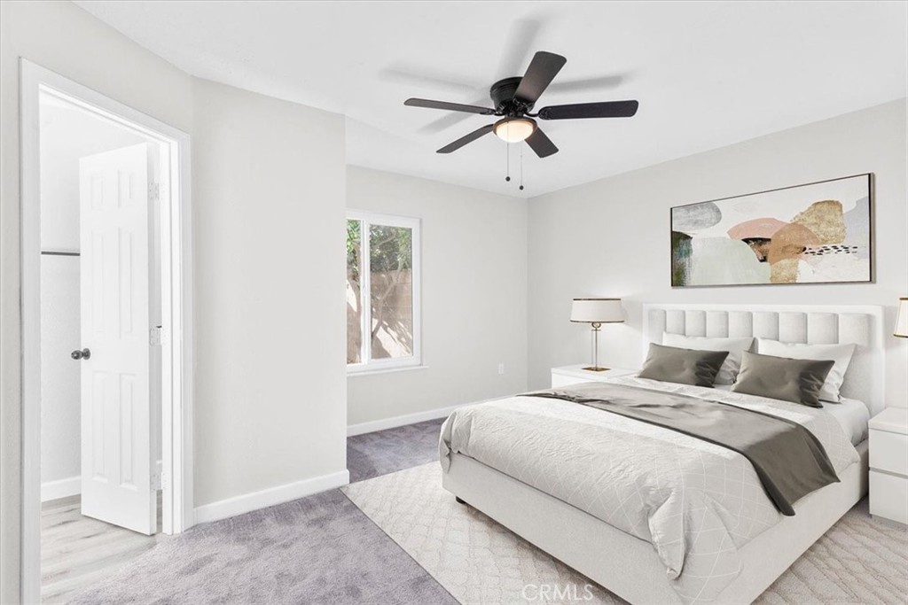 7900 Temecula Place Riverside, CA 92503 - Photo 15 of 22 a bedroom with a large bed and a chandelier