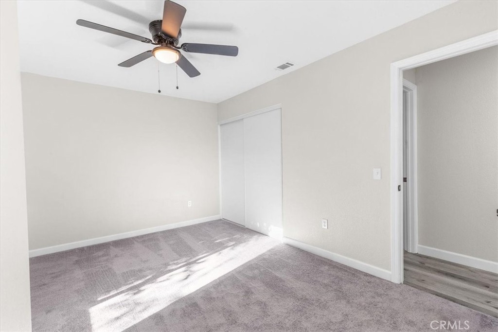 7900 Temecula Place Riverside, CA 92503 - Photo 18 of 22 an empty room with a ceiling fan and a window