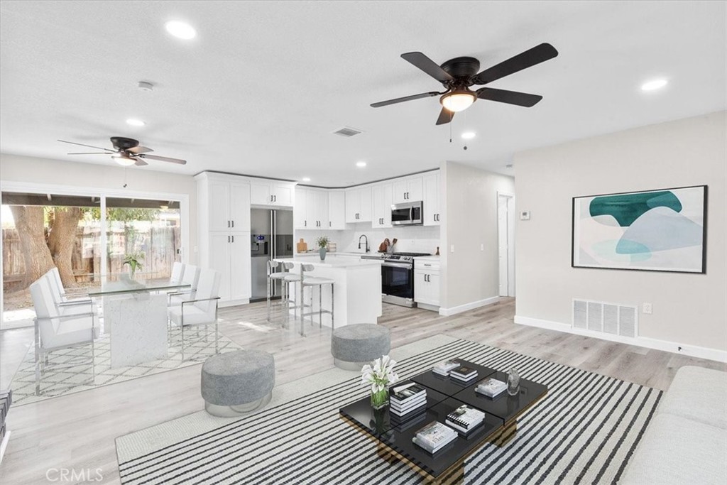 7900 Temecula Place Riverside, CA 92503 - Photo 2 of 22 a living room with dining area furniture and kitchen view