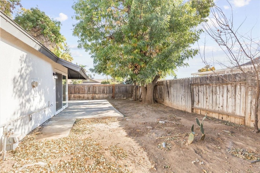 7900 Temecula Place Riverside, CA 92503 - Photo 22 of 22 a view of a backyard with wooden fence and large trees