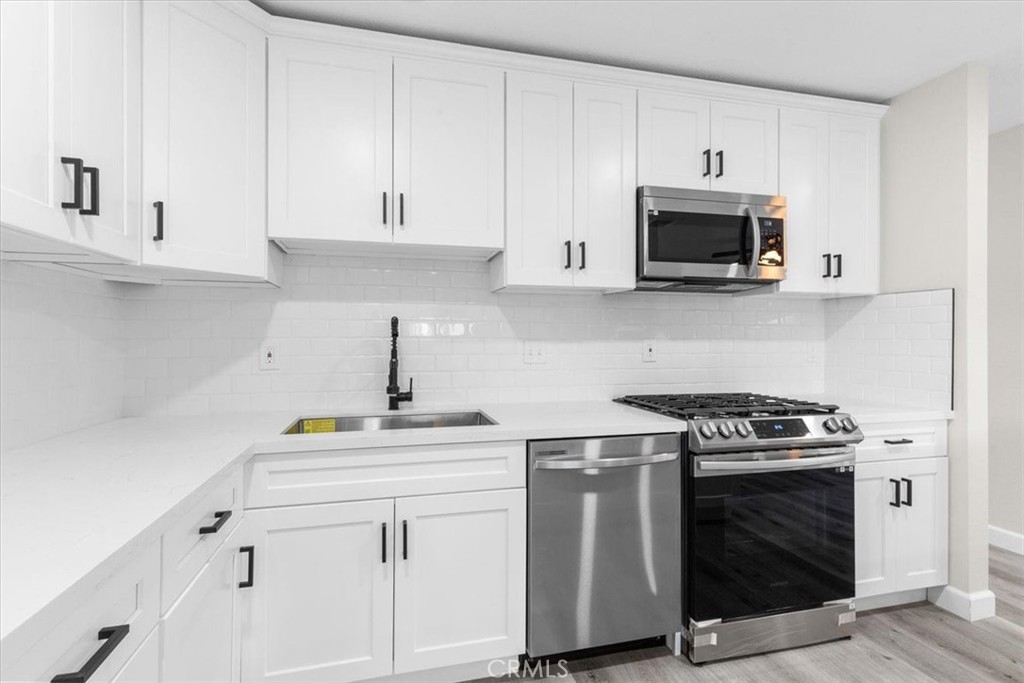 7900 Temecula Place Riverside, CA 92503 - Photo 9 of 22 a kitchen with white cabinets and appliances