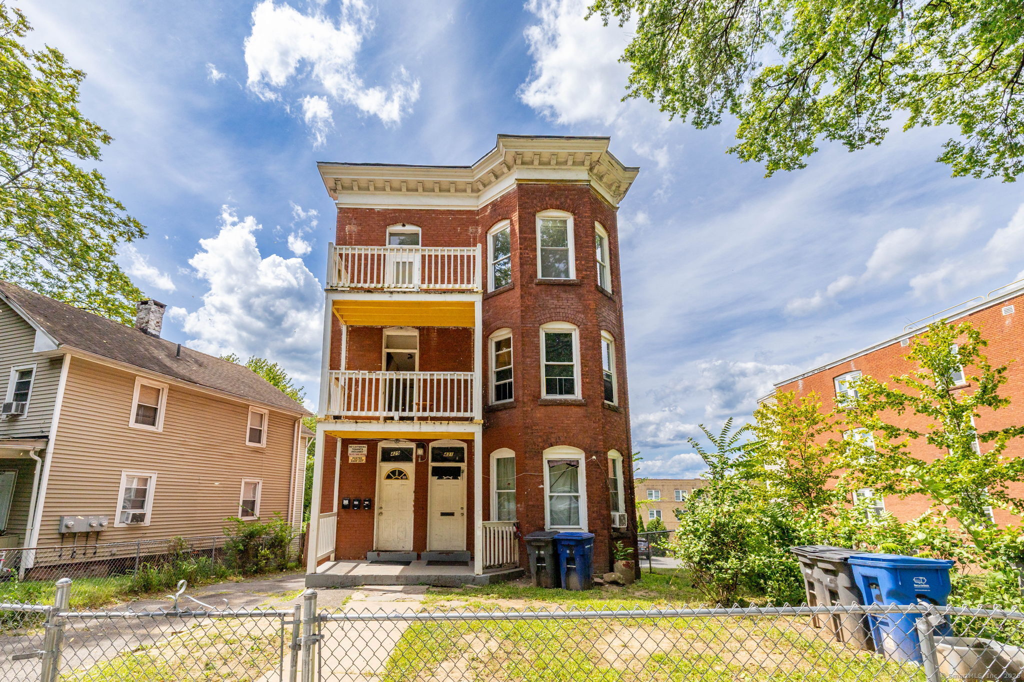 a front view of a residential houses with yard