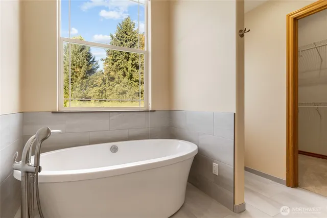 a white bath tub sitting next to a window