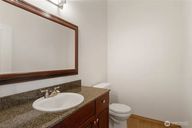 a bathroom with a sink a toilet and mirror