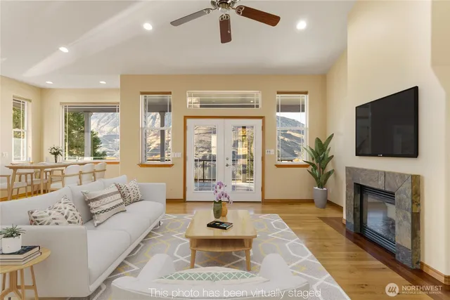 a living room with furniture a flat screen tv and a fireplace