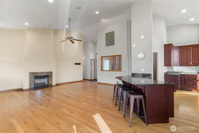 a view of kitchen with granite countertop cabinets table and chairs
