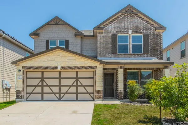 a view of a brick house with large windows