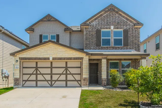 a view of a brick house with large windows