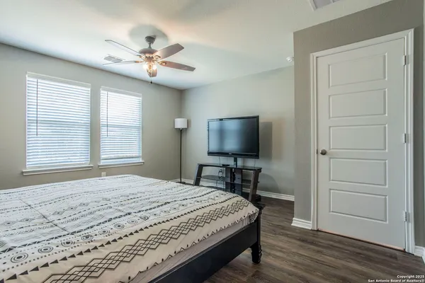 a spacious bedroom with a bed and a window