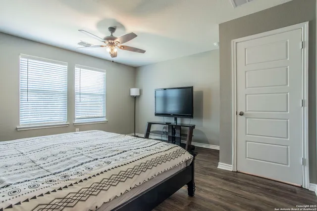 a spacious bedroom with a bed and a window