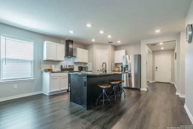 a room with pool table and windows