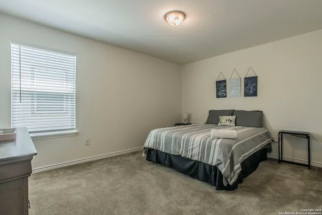 a bedroom with a bed and a dresser