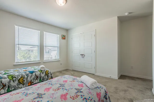 a kitchen with stainless steel appliances granite countertop a refrigerator a stove a sink a dining table and chairs with wooden floor