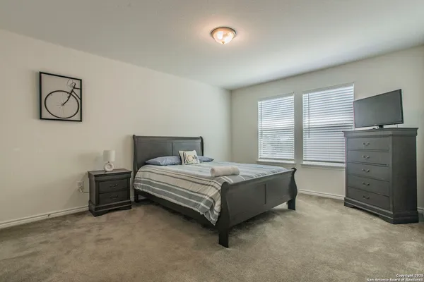 a bedroom with two beds and a window