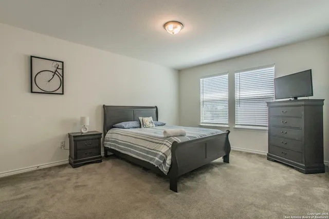 a bedroom with two beds and a window