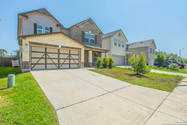 a dining room with wooden floor a chandelier a wooden table and chairs